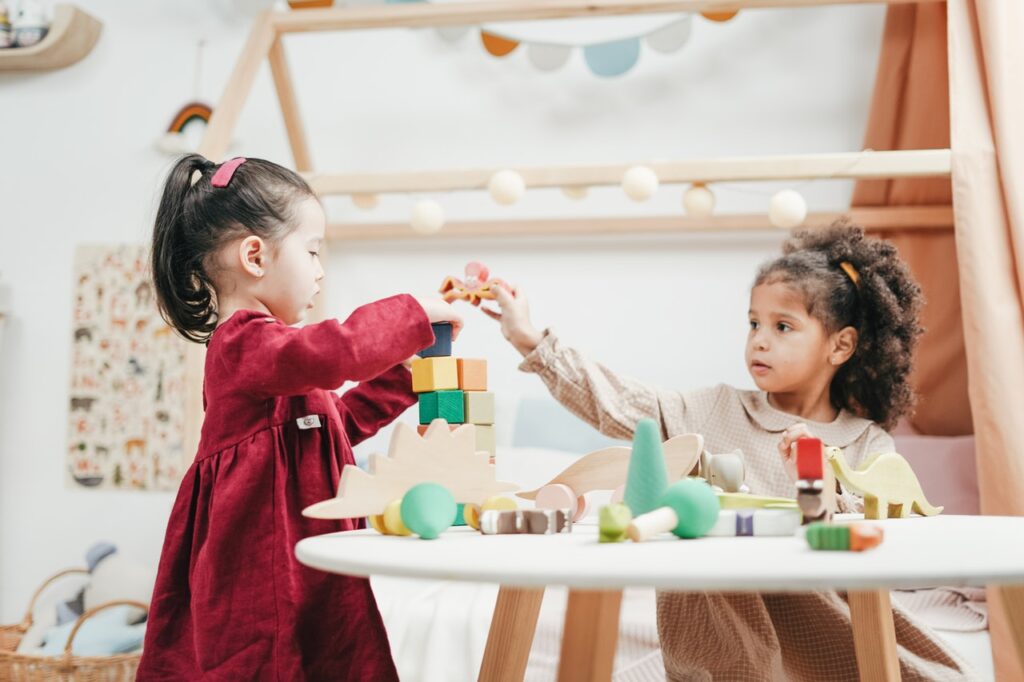 two kid are playing in learning academy